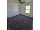 Comfortable bedroom with carpet, a ceiling fan, natural light from the window, and neutral walls at 6024 Boulder Dr, Anderson, IN 46013