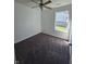 Cozy bedroom with soft carpet, a ceiling fan, a window with natural light, and painted white walls at 6024 Boulder Dr, Anderson, IN 46013
