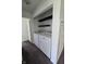 Functional laundry area with a washer, dryer, and two floating shelves for storage at 6024 Boulder Dr, Anderson, IN 46013
