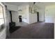 Open-concept living room with a view of the updated kitchen, cozy fireplace, and modern finishes at 6024 Boulder Dr, Anderson, IN 46013
