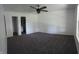 Large primary bedroom with plush carpet, neutral walls, ceiling fan, and a walk-in closet at 6024 Boulder Dr, Anderson, IN 46013