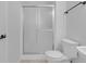 Bright bathroom featuring a glass-enclosed shower and neutral tile flooring at 12997 Bartlett Dr, Fishers, IN 46037