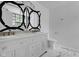Bright bathroom featuring tiled flooring, dual sink vanity, a mirror and a commode at 12997 Bartlett Dr, Fishers, IN 46037