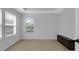 Bright bedroom featuring neutral walls, plush carpet, a tray ceiling and a base cabinet for storage at 12997 Bartlett Dr, Fishers, IN 46037