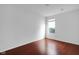Minimalist bedroom with hardwood flooring, a single window, and neutral walls at 12997 Bartlett Dr, Fishers, IN 46037