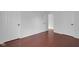 Neutral bedroom featuring hardwood floors, white doors, and natural light at 12997 Bartlett Dr, Fishers, IN 46037