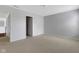This bedroom has neutral colored walls and carpeting, and a view into the hallway at 12997 Bartlett Dr, Fishers, IN 46037