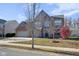Inviting two-story home with brick accents, an attached two-car garage, and mature landscaping at 12997 Bartlett Dr, Fishers, IN 46037