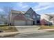 Traditional two-story home with brick facade, attached two-car garage, and spacious front lawn at 12997 Bartlett Dr, Fishers, IN 46037