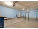 Open garage featuring concrete flooring, and bright blue walls at 12997 Bartlett Dr, Fishers, IN 46037
