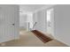 Hallway showing a carpeted floor and a banister, providing access to several rooms at 12997 Bartlett Dr, Fishers, IN 46037