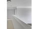 This hallway is neutral-colored with white trim at 12997 Bartlett Dr, Fishers, IN 46037