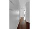 Hallway featuring hardwood flooring and neutral walls, leading to a sunlit room at 12997 Bartlett Dr, Fishers, IN 46037
