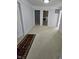 Hallway with laundry room and other doorways, featuring neutral carpet at 12997 Bartlett Dr, Fishers, IN 46037