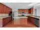 Well-equipped kitchen featuring a central island, stainless steel appliances and wooden cabinetry at 12997 Bartlett Dr, Fishers, IN 46037