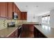 Bright kitchen with an island, stainless steel appliances and a view into the living area at 12997 Bartlett Dr, Fishers, IN 46037