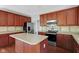 Modern kitchen with stainless steel appliances, center island, and ample counter space at 12997 Bartlett Dr, Fishers, IN 46037