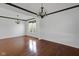 Spacious living room featuring hardwood floors, crown molding, and decorative chandeliers at 12997 Bartlett Dr, Fishers, IN 46037