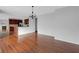 Open-concept living space with hardwood floors and views into the kitchen at 12997 Bartlett Dr, Fishers, IN 46037