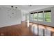 Open living space with gleaming hardwood floors and large windows for ample natural light at 12997 Bartlett Dr, Fishers, IN 46037
