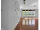 Modern living room with hardwood floors and a series of bright windows at 12997 Bartlett Dr, Fishers, IN 46037