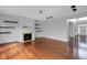 Bright living room featuring hardwood floors, fireplace, and built-in shelving at 12997 Bartlett Dr, Fishers, IN 46037