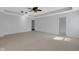 This bedroom has a tray ceiling with ceiling fan, neutral colors, and a view into the bathroom at 12997 Bartlett Dr, Fishers, IN 46037