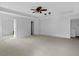 This bedroom has a tray ceiling with ceiling fan, neutral colors, and a view into the hallway at 12997 Bartlett Dr, Fishers, IN 46037