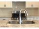 Modern kitchen features stainless steel appliances, white cabinets, and a granite countertop at 1684 Linden Ln, Greenfield, IN 46140
