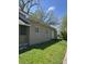 Tan single-story home with a well-maintained lawn and mature trees adding natural beauty at 2270 Wheeler St, Indianapolis, IN 46218