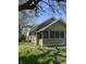 View of the side of the house, highlighting its architecture and landscaping in a peaceful, sunny setting at 2270 Wheeler St, Indianapolis, IN 46218