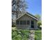 Charming home with a quaint front yard featuring green grass and the walkway to the front door on a sunny day at 2270 Wheeler St, Indianapolis, IN 46218