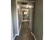 The long hallway boasts beautiful laminate floors and leads to various rooms at 2270 Wheeler St, Indianapolis, IN 46218
