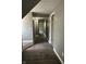 Hallway with modern floors, neutral walls, leading to various rooms, providing a clear and connected layout at 2270 Wheeler St, Indianapolis, IN 46218