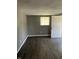 Inviting room featuring hardwood floors, neutral paint, and a bright window with a door, offering a comfortable atmosphere at 2270 Wheeler St, Indianapolis, IN 46218