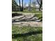 Lush front yard featuring a concrete driveway surrounded by vibrant spring flowers at 2270 Wheeler St, Indianapolis, IN 46218