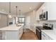 Modern kitchen with stainless steel appliances, quartz countertops, breakfast bar, and wood flooring at 7370 Broadview Ln, McCordsville, IN 46055