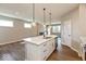 Bright kitchen with island pendant lighting and views to the fireplace at 7370 Broadview Ln, McCordsville, IN 46055