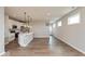 Open concept kitchen and living space featuring white cabinets, stainless appliances, and hardwood floors at 7370 Broadview Ln, McCordsville, IN 46055