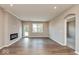 Open living room featuring hardwood floors, an electric fireplace, lots of natural light, and neutral paint at 7370 Broadview Ln, McCordsville, IN 46055