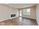 Bright living room features a fireplace, wood floors, and a glass door leading to the outside at 7370 Broadview Ln, McCordsville, IN 46055