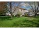 Spacious backyard with lush green grass, mature trees, and a fenced perimeter, ideal for outdoor activities at 9563 England Ct, Noblesville, IN 46060