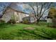 Private backyard showcasing a green lawn, established trees, and a fenced enclosure for added security at 9563 England Ct, Noblesville, IN 46060