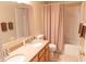 Bathroom featuring a double sink vanity with tan countertops, matching shower curtain, and framed mirror at 9563 England Ct, Noblesville, IN 46060