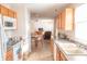 Bright kitchen featuring wooden cabinetry, modern appliances, and a seamless transition into the dining and living areas at 9563 England Ct, Noblesville, IN 46060