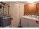 Functional laundry room with a washer, dryer, water heater, and ample storage space for household needs at 9563 England Ct, Noblesville, IN 46060
