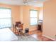 Bright office space with hardwood floors, dual windows with curtains, and vintage desk at 9563 England Ct, Noblesville, IN 46060