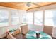 Bright sunroom with a glass-top table, multiple windows, and a door for access to the outdoors at 9563 England Ct, Noblesville, IN 46060