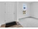 Bright entryway with gray carpet, white walls, and view from large window at 1145 Bevy Blvd, Danville, IN 46122