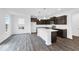 Modern kitchen boasting dark cabinetry, a center island, and stainless steel appliances at 1145 Bevy Blvd, Danville, IN 46122